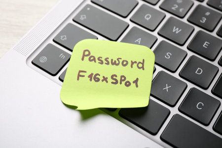Paper note with password on laptop, closeupの写真素材