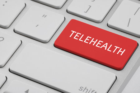 Red button with word Telehealth on computer keyboard, closeupの写真素材