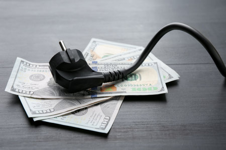 Electrical wire with plug on black wooden table, closeupの写真素材
