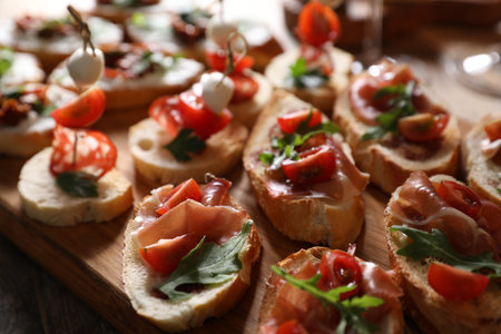 Different delicious bruschettas on wooden table, closeupの写真素材