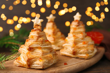 Christmas trees made with puff pastry, red caviar and festive decor on table, closeupの写真素材