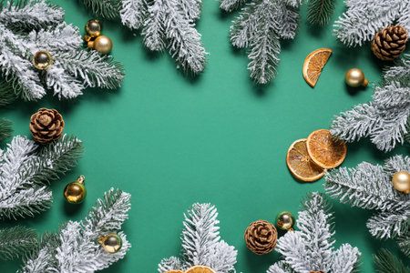 Flat lay composition with fir tree branches and other Christmas decor on green background, space for textの写真素材