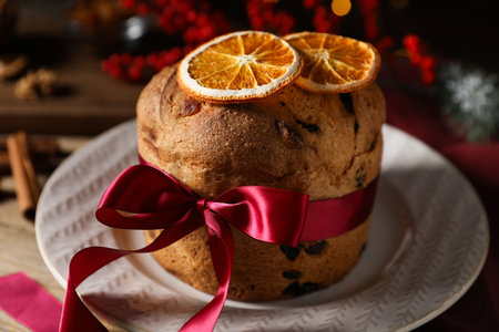 Christmas food. Delicious Panettone cake, spices and festive decor on table, closeupの写真素材