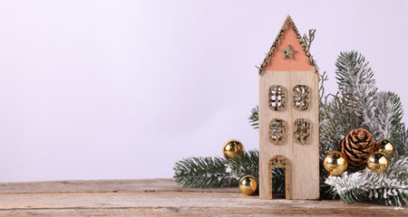 Fir tree branches and other Christmas decor on wooden table against light gray background, closeup. Space for textの写真素材