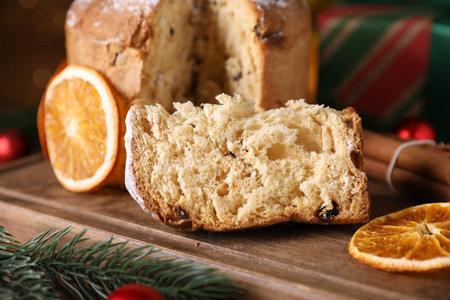 Christmas food. Delicious Panettone cake and festive decor on table, closeup