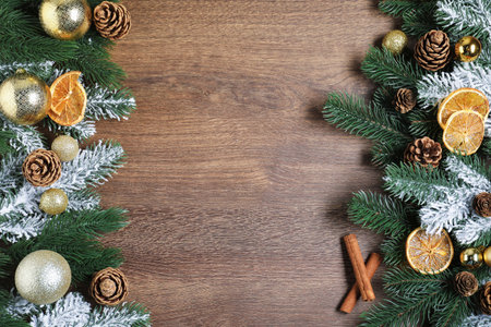 Flat lay composition with fir tree branches, spices and other Christmas decor on wooden table. Space for textの写真素材