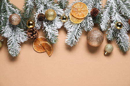 Flat lay composition with fir tree branches and other Christmas decor on beige background, space for textの写真素材