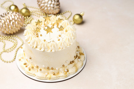 Delicious cake with Christmas decor on beige table, closeup. Space for textの写真素材