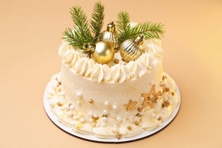 Delicious cake with Christmas decor on beige background, closeup