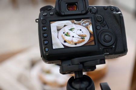 Shooting croissants at table in studio, focus on camera screen. Professional food photographyの写真素材