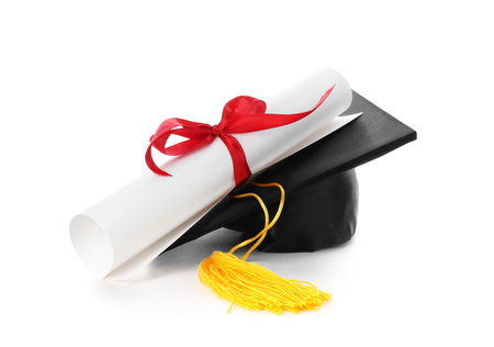 Diploma and graduation hat isolated on whiteの写真素材