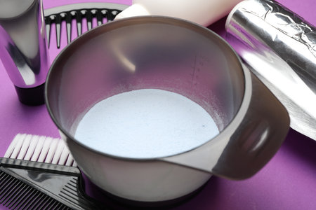 Professional tools and products for hair dyeing on purple background, closeupの写真素材