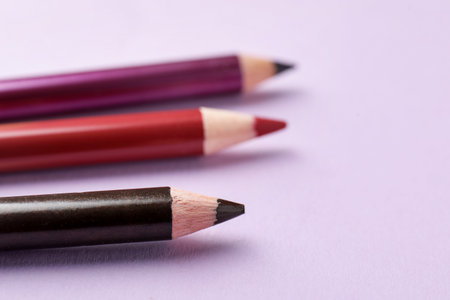 Color pencils on pink background, closeup. Space for textの写真素材