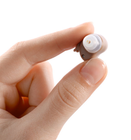 Woman with hearing aid on white background, closeupの写真素材