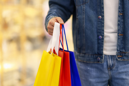 Man with shopping bags in mall, closeupの写真素材