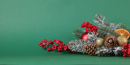 Fir tree branches and other Christmas decor on green background. Space for textの写真素材