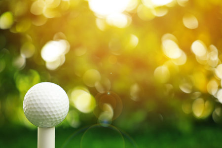 Golf ball and tee against blurred background, closeupの写真素材