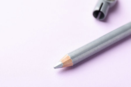 Color eye pencil on pink background, closeup.の写真素材