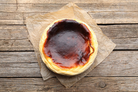 Tasty Basque cheesecake on wooden table, top viewの写真素材