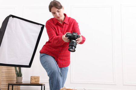 Woman taking picture of croissants in studio, space for text. Professional food photographyの写真素材
