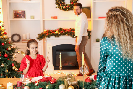 Happy family setting table and decorating room for Christmas, selective focusの写真素材