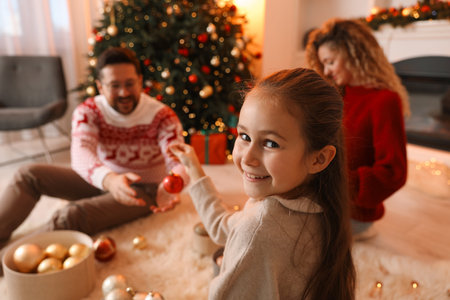 Happy family with ornaments near Christmas tree at home, selective focusの写真素材