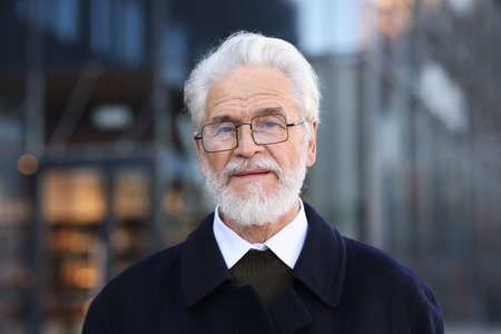 Handsome senior man with gray hair on city street