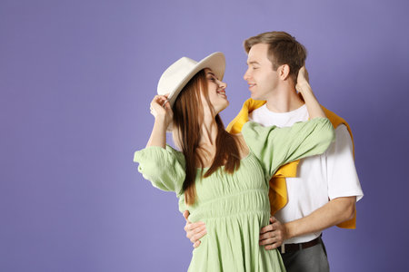 Cute couple hugging on violet background, space for text. Romantic dateの写真素材