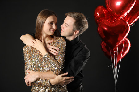 Lovely couple hugging on black background. Romantic dateの写真素材