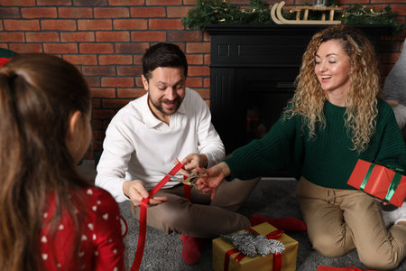 Happy family decorating Christmas gifts at homeの写真素材