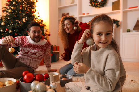 Happy family with ornaments near Christmas tree at home, selective focusの写真素材