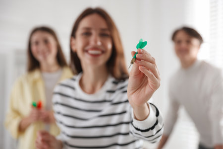 Woman playing darts and her colleagues in office, selective focusの写真素材