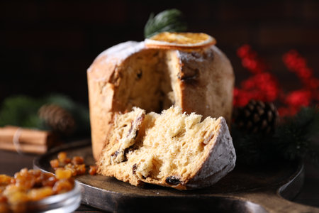 Christmas food. Delicious Panettone cake and festive decor on wooden table, closeupの写真素材
