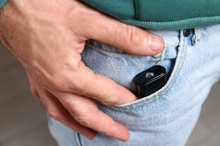 Man with hidden spy camera in his pocket, closeupの写真素材