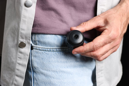 Man with hidden spy camera in his pocket, closeupの写真素材
