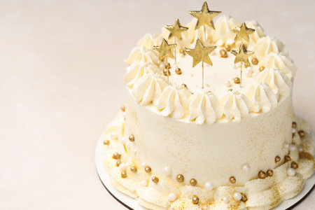 Delicious cake with Christmas decor on beige table, closeup. Space for textの写真素材