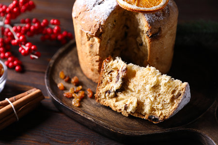 Christmas food. Delicious Panettone cake and festive decor on wooden table, closeupの写真素材