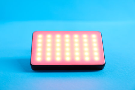 Stylish LED lamp on light blue background, closeupの写真素材