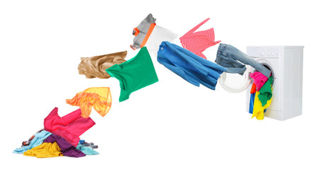 Colorful clothes flying out of washing machine against white backgroundの写真素材