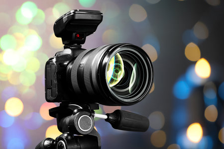 Professional camera against blurred lights, bokeh effectの写真素材