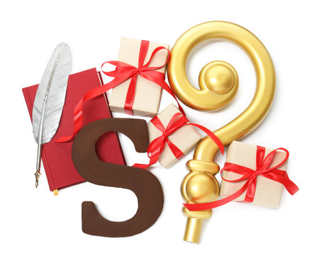 Saint Nicholas (Sinterklaas) day. Book, crosier, feather, chocolate letter S and gift boxes isolated on white, top viewの写真素材