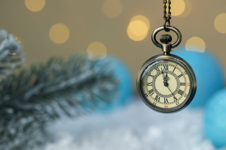 Pocket watch against blurred lights, closeup with space for text. New Year greeting cardの写真素材