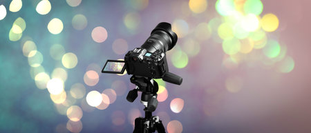 Professional camera against blurred lights, bokeh effect, Banner designの写真素材