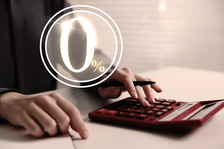 Woman with paperwork using calculator at table, closeup. 0 percent representing zero commission