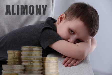 Sad little boy, double exposure with and stacked coins.の写真素材