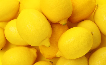Fresh whole lemons on yellow background, flat lay