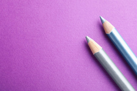 Different pencils on purple background, top view. Space for textの写真素材