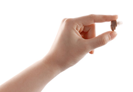 Woman with hearing aid on white background, closeupの写真素材