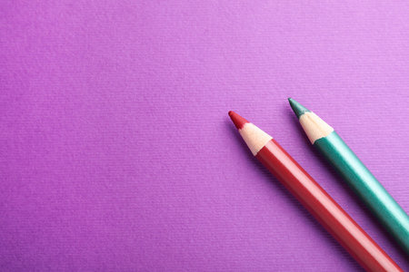 Different pencils on purple background, top view. Space for textの写真素材