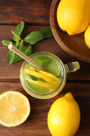 Fresh lemonade in mason jar, lemons and mint on wooden table, flat layの写真素材